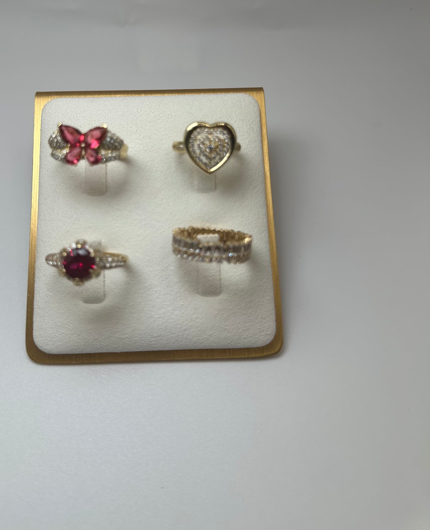 Discover the epitome of elegance with this stunning collection of gold rings! Featuring four unique designs, each crafted with exquisite detail and vibrant gemstones. This set includes: