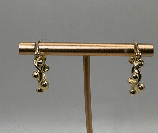 These elegant gold drop earrings feature a captivating organic design that mimics twisting vines or gentle waves, adorned with clusters of smooth, polished gold spheres.